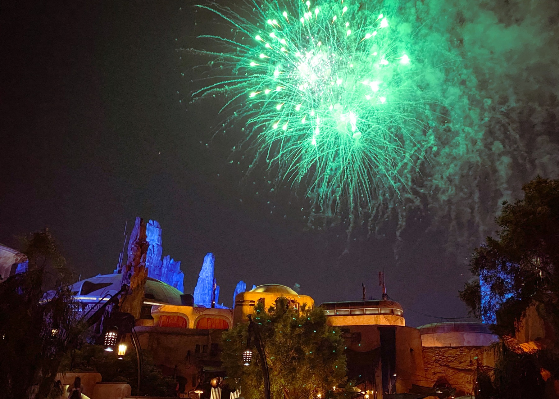 Fireworks over a colorful Star Wars themed land at Disney