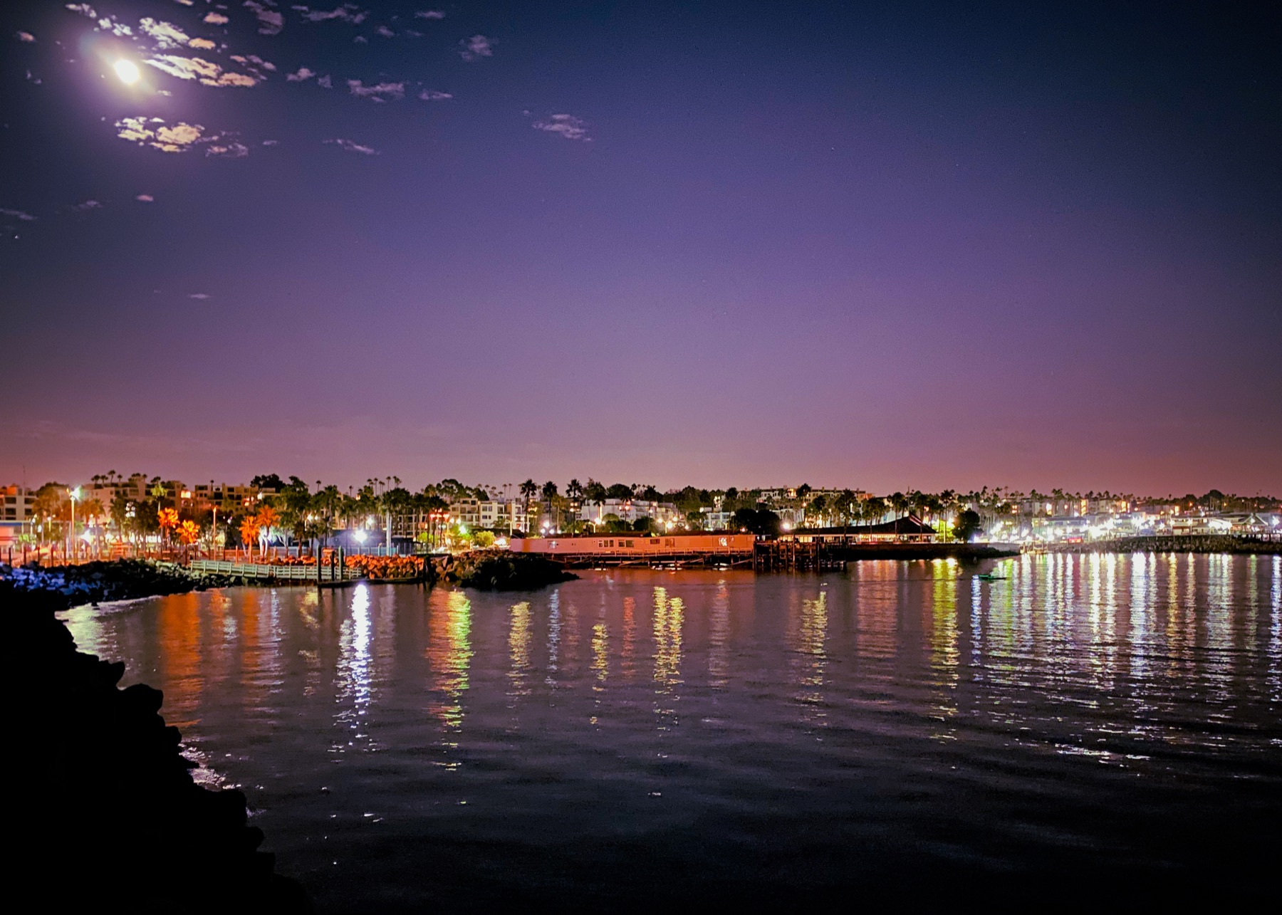 A moonlit Los Angeles harbor reflected in calm water